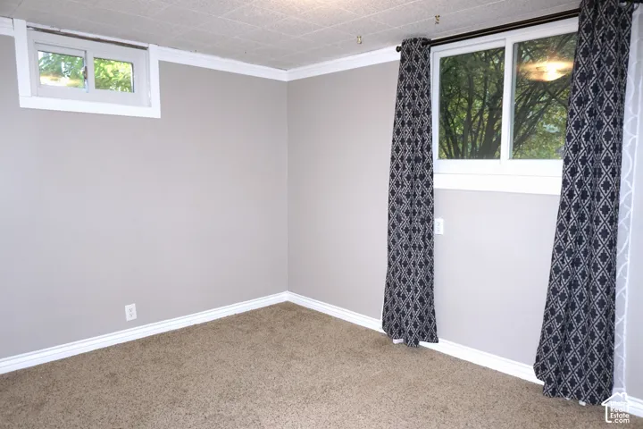 Neutral tone painted walls, textured ceiling, and window with exterior scenery