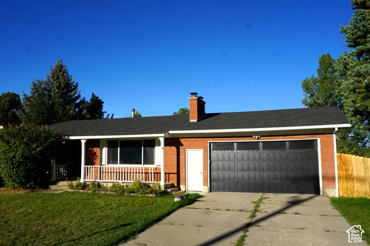 Brick exterior with a dark shingle roof
