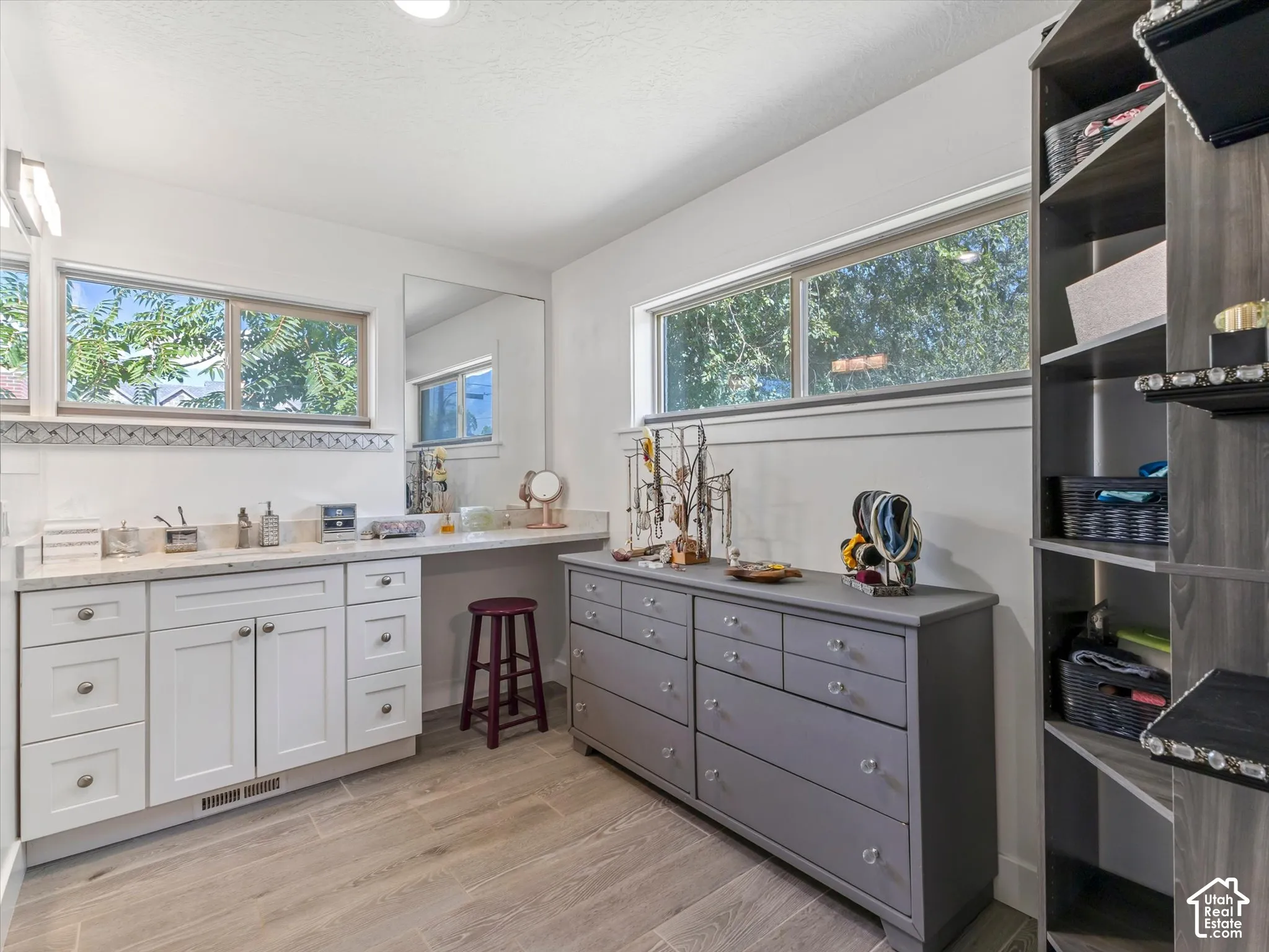 White cabinetry with light-toned countertops and undermount sink