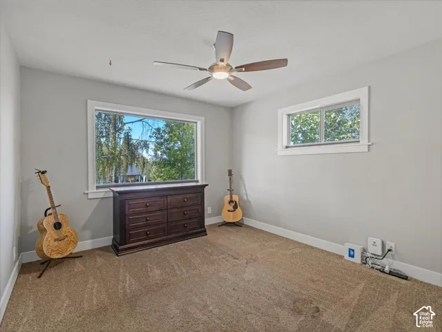 Recessed lighting, ceiling fan, carpeting, two windows, and light gray walls
