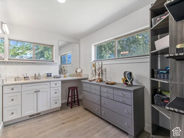 White cabinetry with light-toned countertops and undermount sink