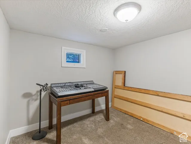 Recessed window with white trim, neutral-toned walls, textured ceiling, and flush mount lighting