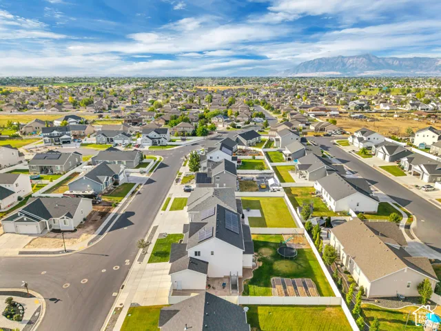 Residential community with paved streets, sidewalks, and green lawns