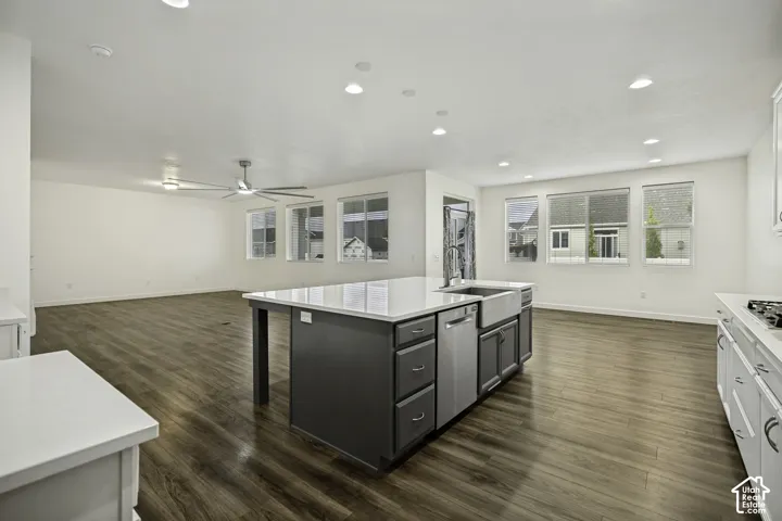 Open-concept living space featuring wood-finish flooring, recessed lighting, and a modern ceiling fan