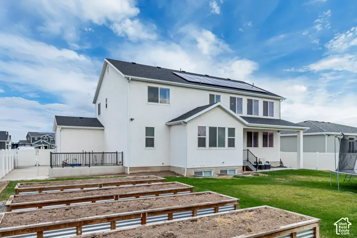 White stucco exterior with a black shingle roof