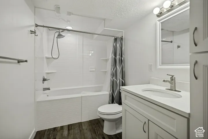 White vanity with integrated sink, brushed nickel faucet, and framed mirror