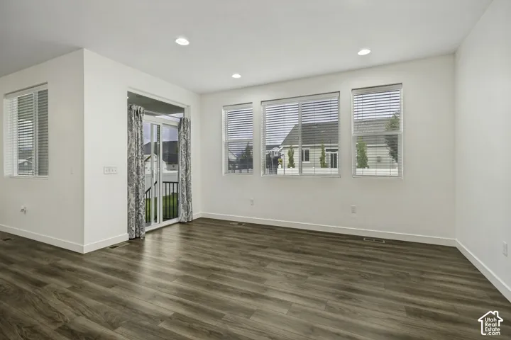 Wood-finish flooring, recessed lighting, multiple windows, and a sliding glass door