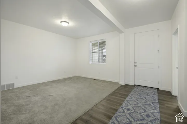 Neutral wall finishes, recessed lighting, and a window with blinds