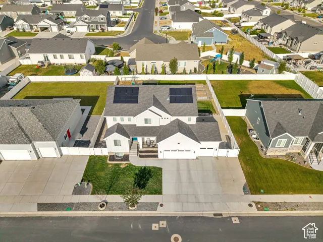 Contemporary residence featuring a two-car garage, solar panels, and a concrete driveway