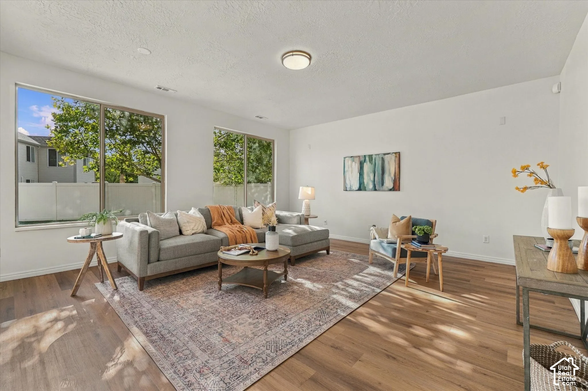 Hardwood-finish flooring, recessed lighting, and large windows