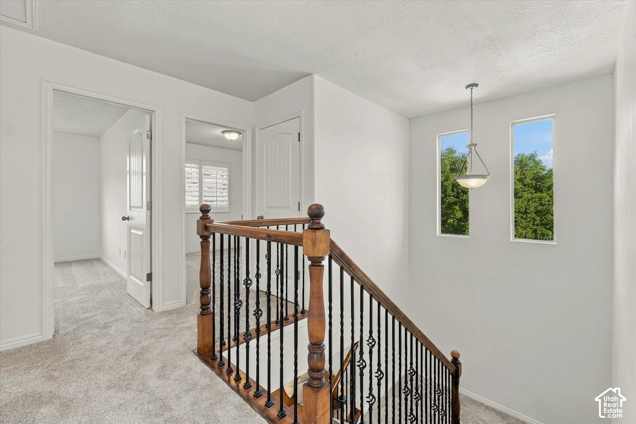 Staircase with wood banister and wrought iron spindles