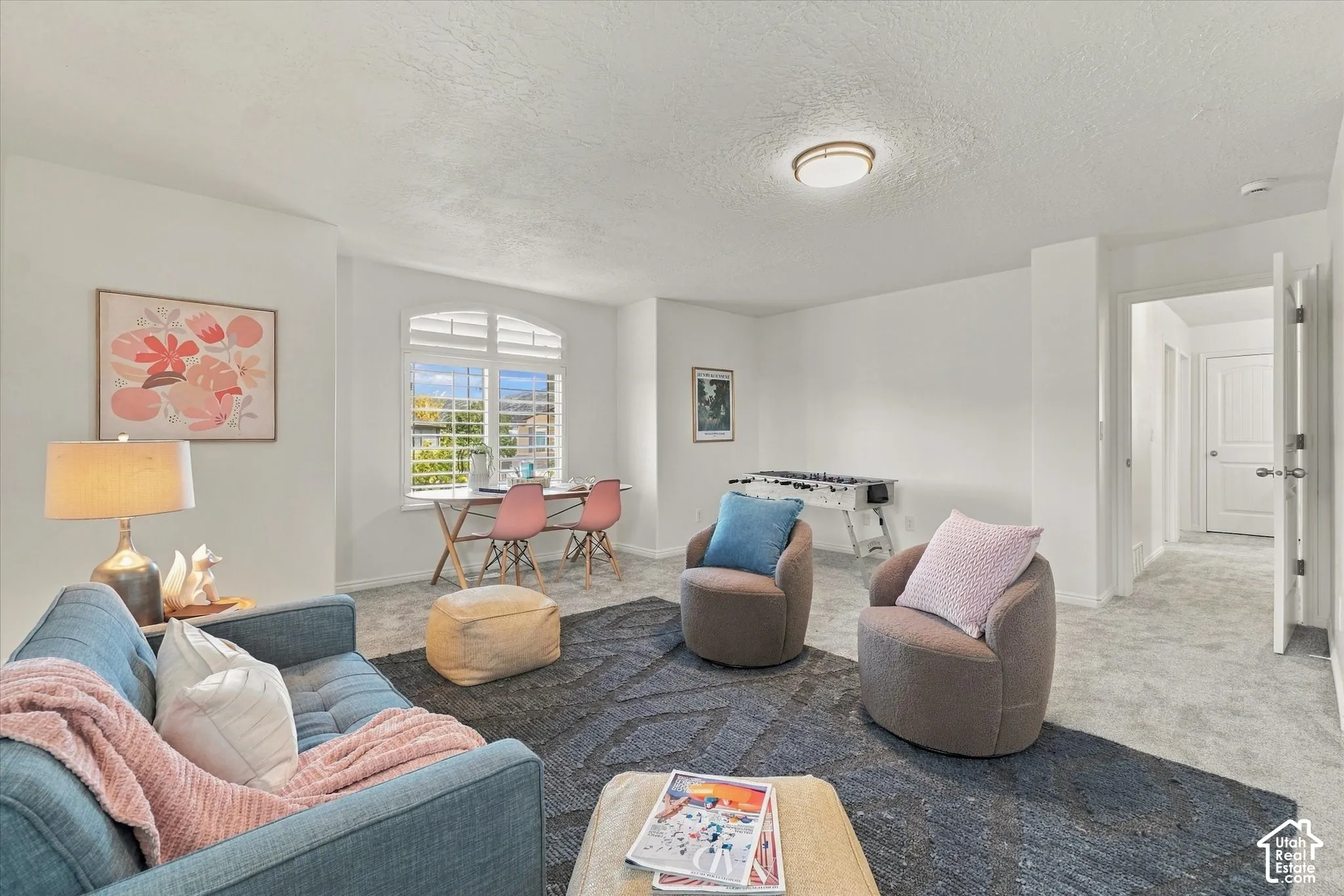Arch-top window with plantation shutters, recessed ceiling lighting, and light gray wall-to-wall carpeting