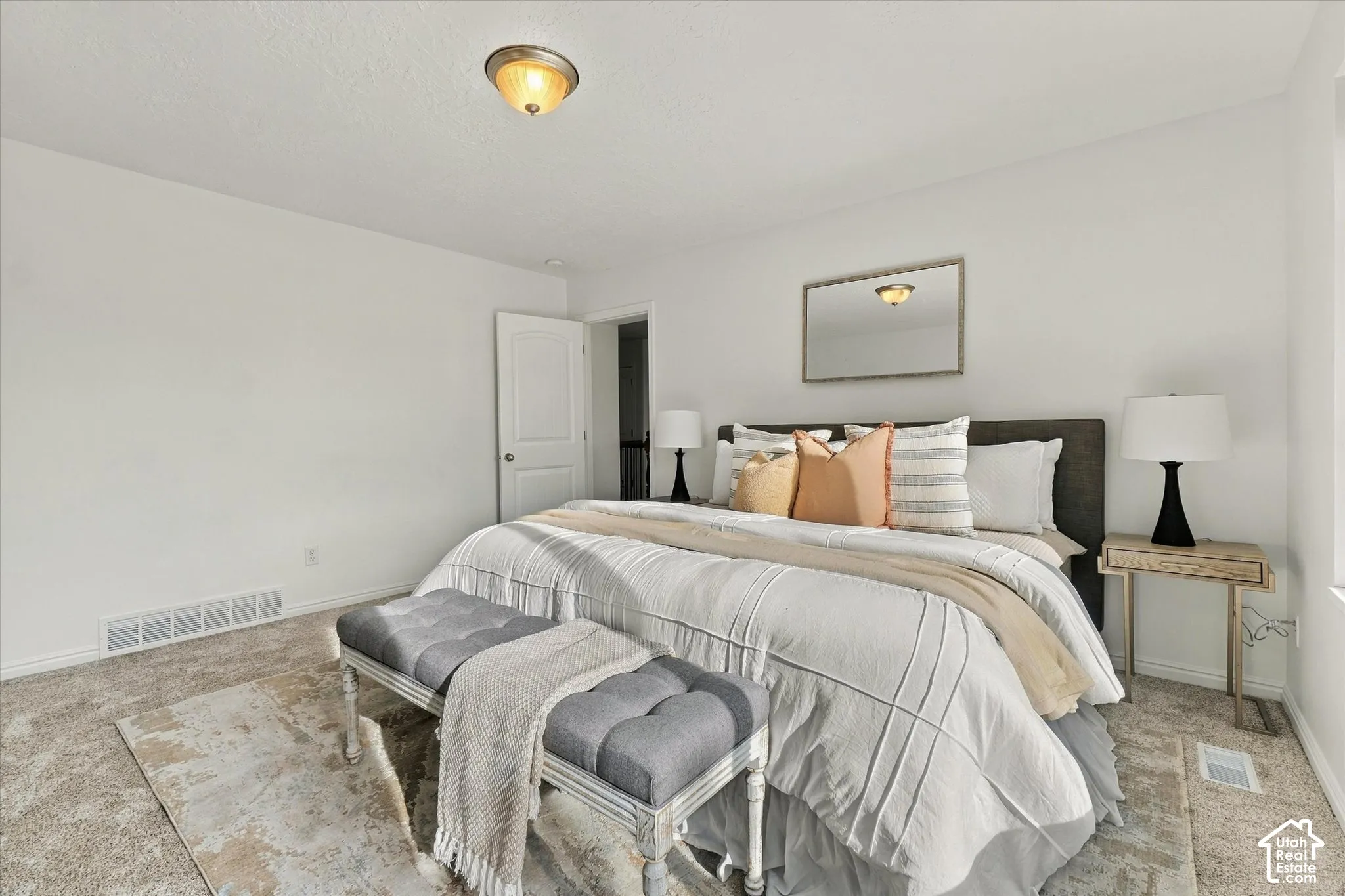 Recessed ceiling light fixture, white walls, and neutral-toned carpet