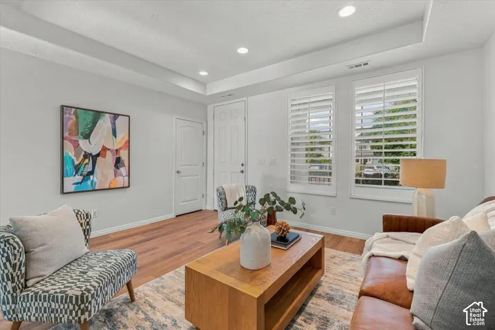 Recessed lighting, tray ceiling, two panel interior doors, and wood-finish flooring