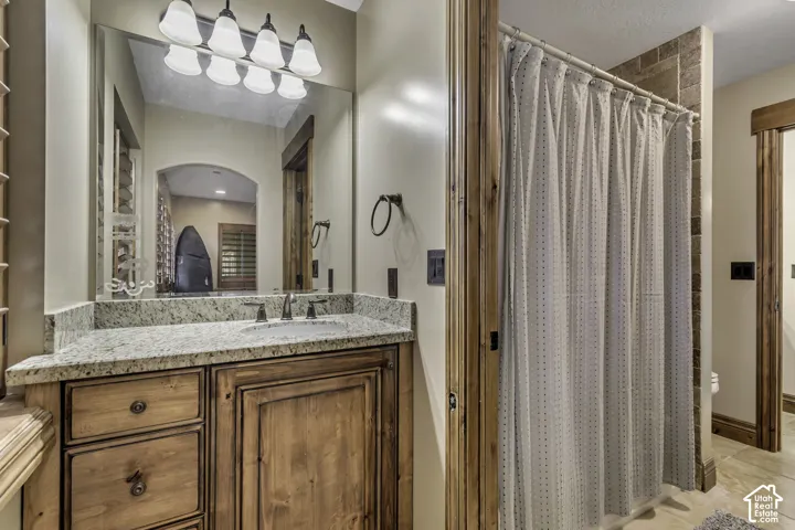 Granite countertop vanity with an undermount sink and dark-finish faucet