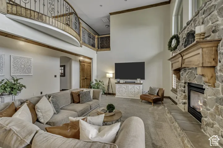 Soaring ceilings complement a stone fireplace with a wood mantle