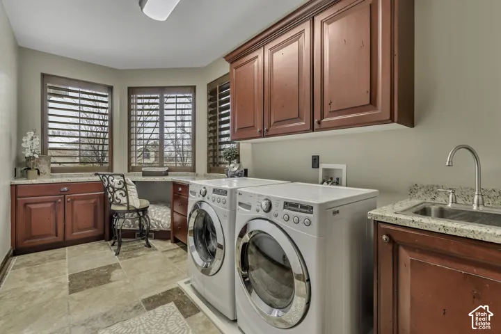 Utility room featuring wood-finish cabinetry, tile flooring, and integrated countertop with sink