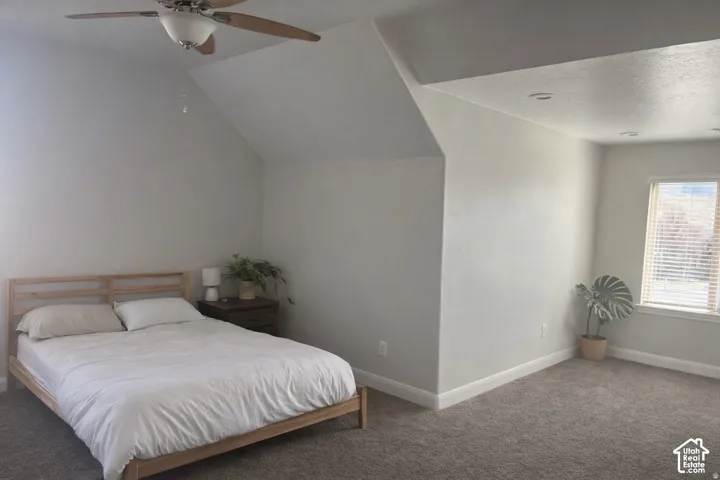 ADU Vaulted ceiling with a ceiling fan, recessed lighting, window with blinds, and gray carpeting