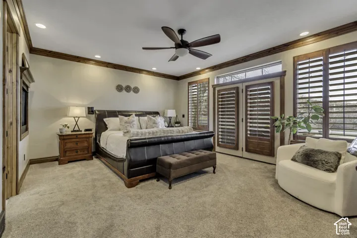 Carpeted bedroom featuring a ceiling fan, recessed lighting, wood trim, and wood-framed doors with integrated louvered shutters
