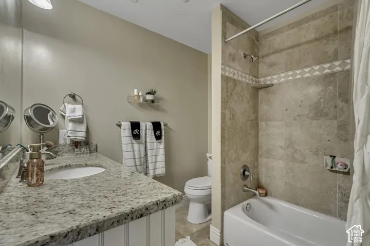 Vanity with a granite countertop, undermount sink, and beadboard paneling
