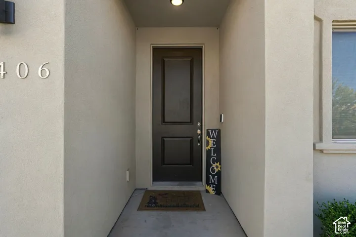 Stucco exterior with prominent address numbers and an integrated overhead light fixture