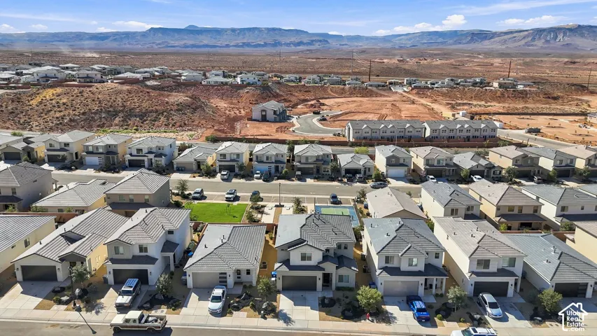Expansive residential development featuring contemporary homes, paved streets, and desert landscaping