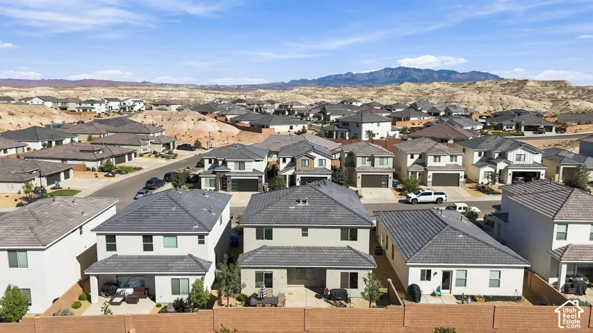 Neighborhood with residential homes featuring tile roofing and attached garages