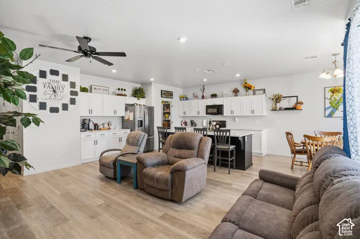 Open concept living area with wood-finish flooring