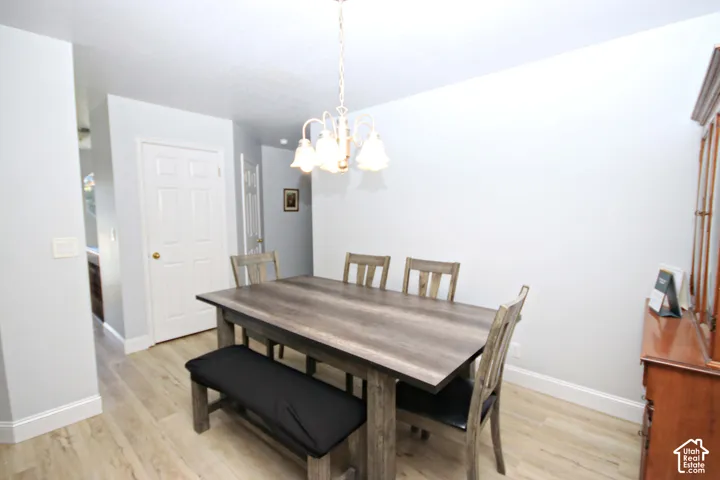 Light wood-finish flooring with white baseboards