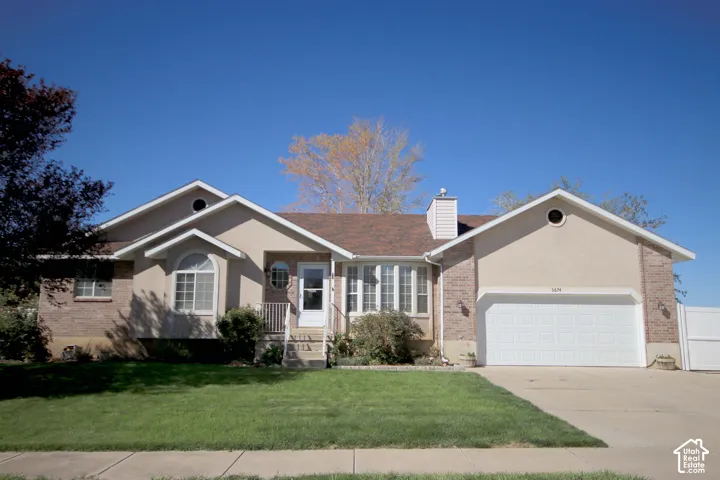 Traditional-style residence featuring a combination brick and stucco exterior