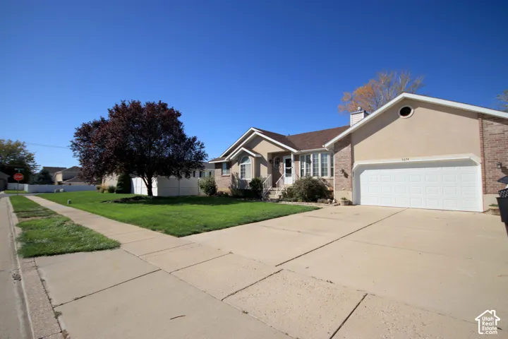 Concrete driveway and sidewalk leading to a two-car garage