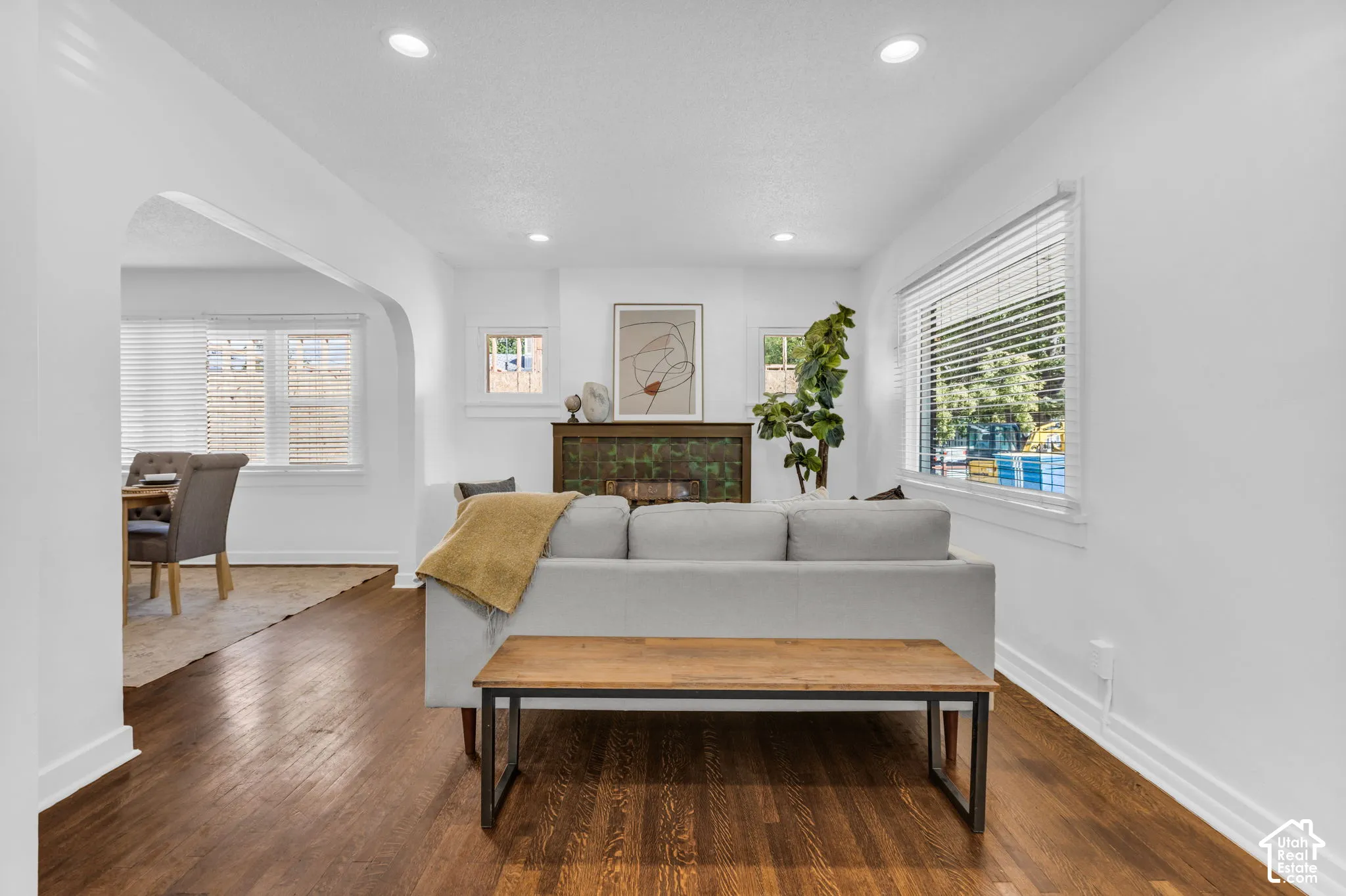 Wood-finish flooring, recessed lighting, and an arched doorway