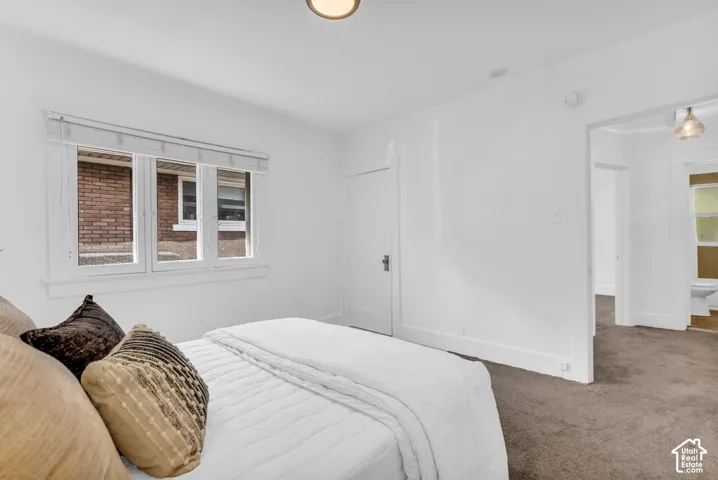White walls with a light-colored ceiling, recessed lighting, and carpeted flooring