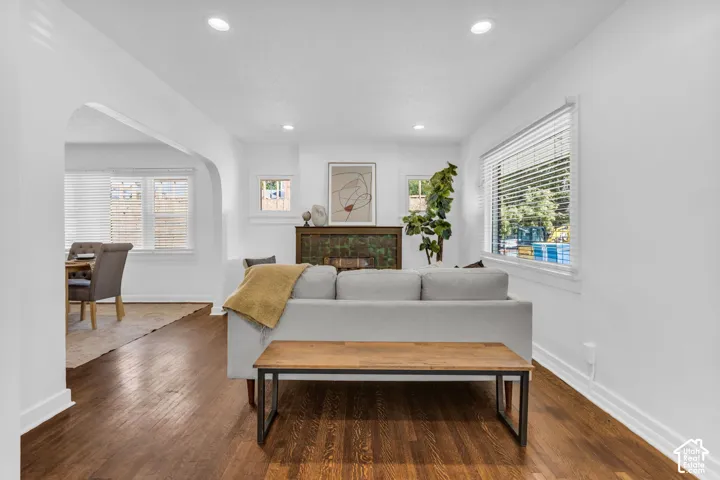 Wood-finish flooring, recessed lighting, and an arched doorway