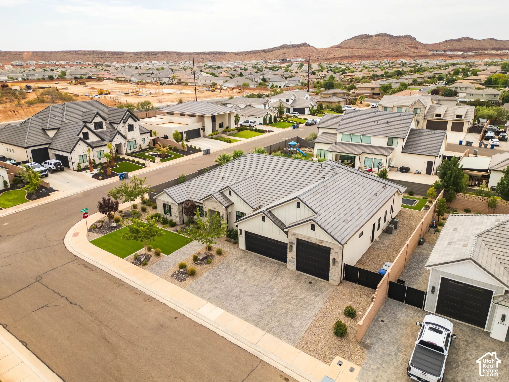 Modern exterior with dark-tiled roofing, attached two-car garage, dedicated RV parking, and mature landscaping