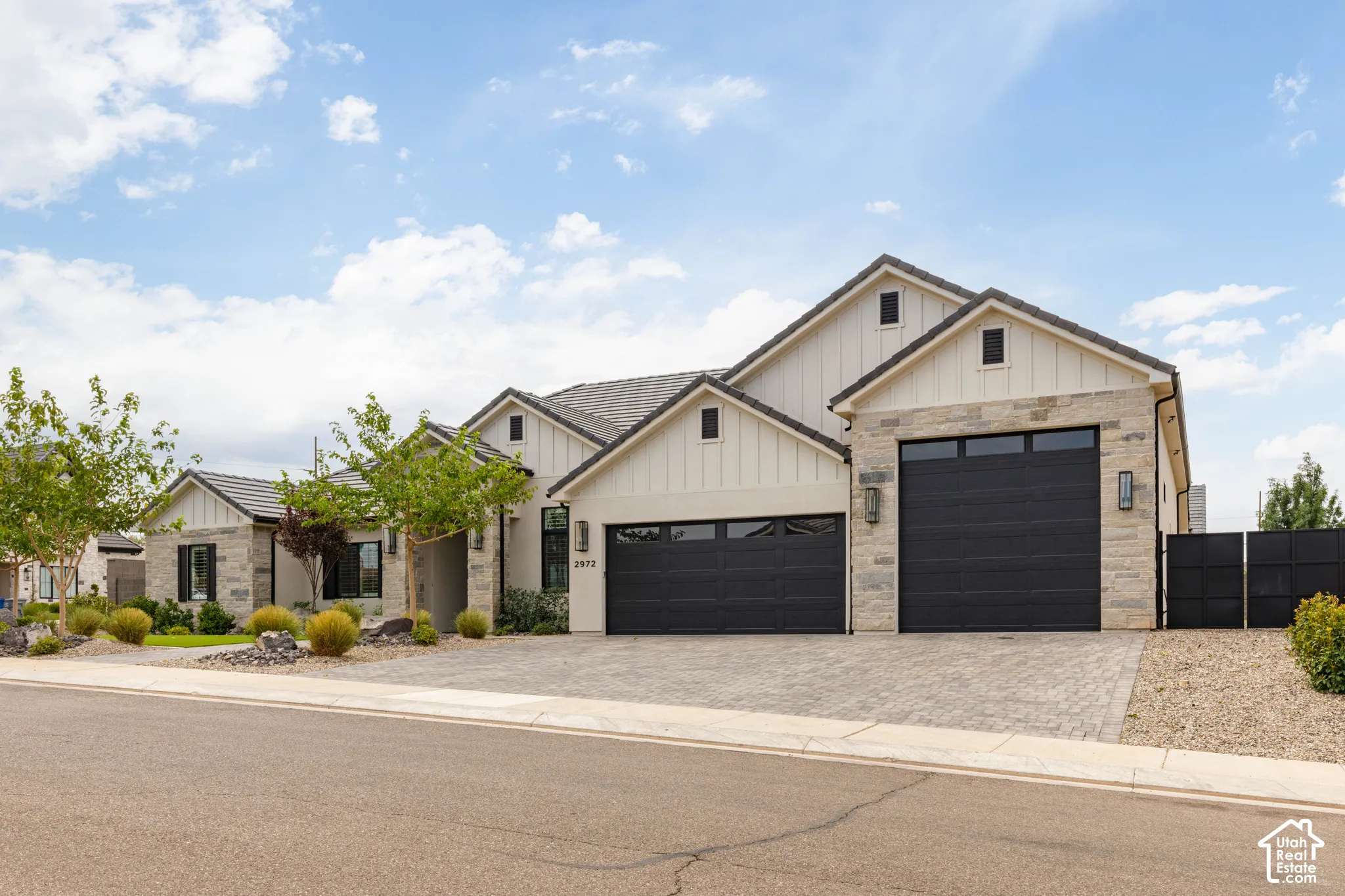 Modern stucco and stone exterior with board and batten gables