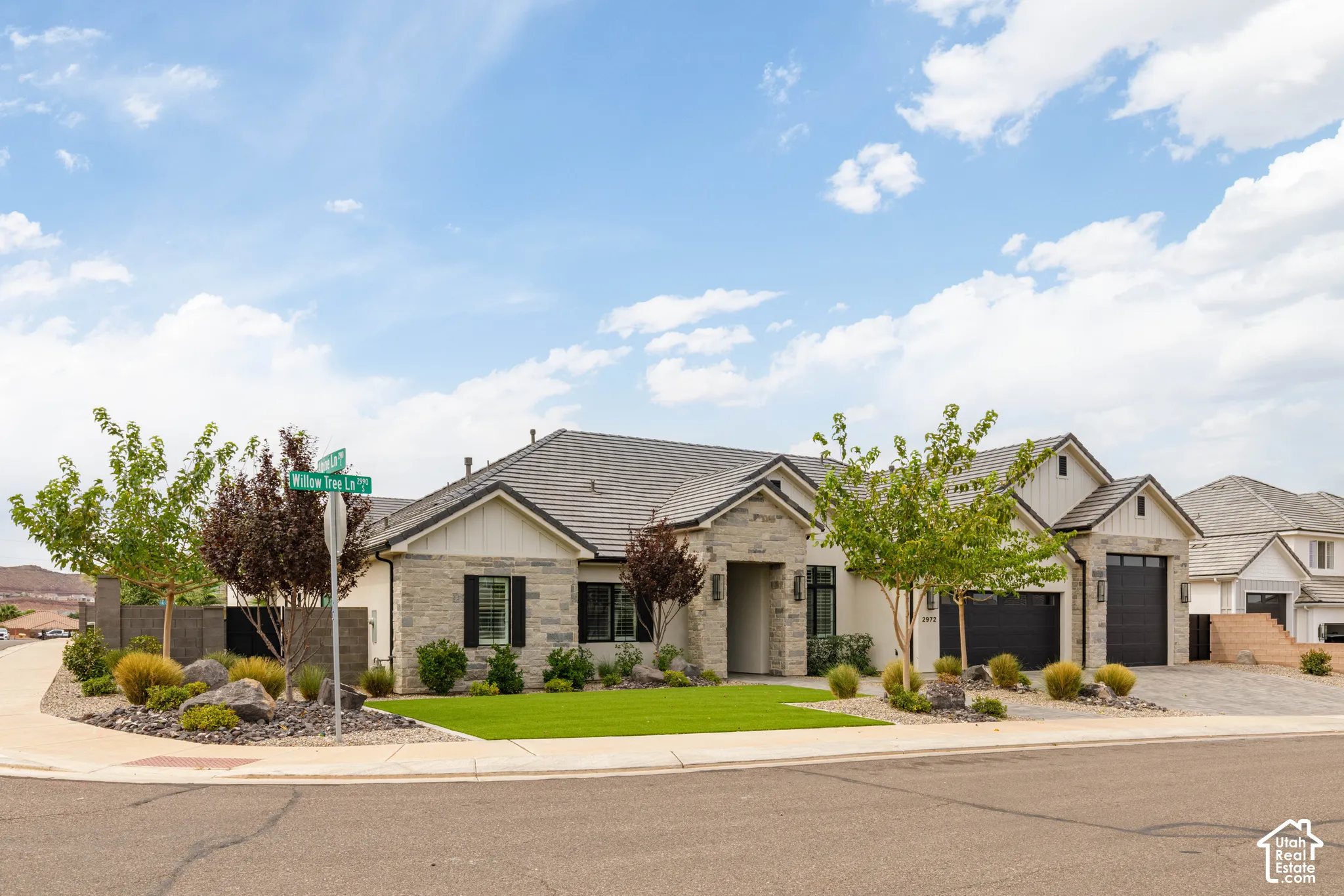 Stone and siding exterior with a dark tile roof