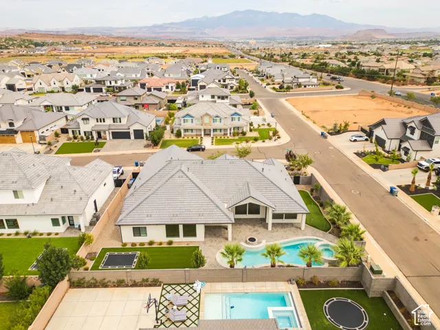 Private backyard featuring a swimming pool, integrated spa, and manicured landscaping