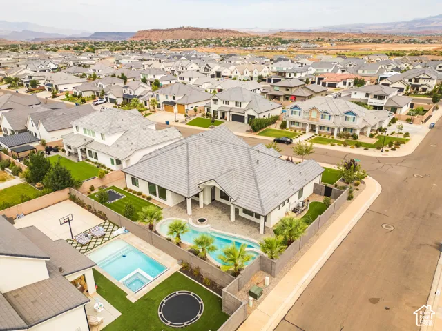 Contemporary exterior with a tiled roof, private swimming pool, landscaped backyard, and a paved patio area