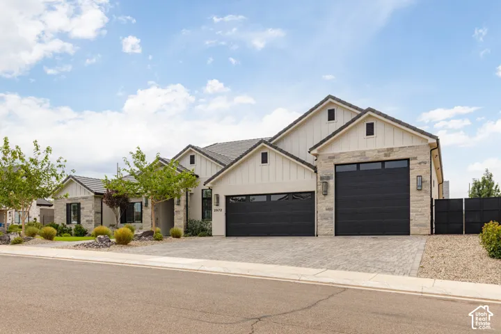 Modern stucco and stone exterior with board and batten gables