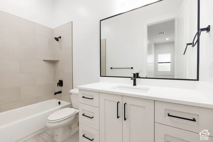 White vanity with a rectangular undermount sink and matte black faucet