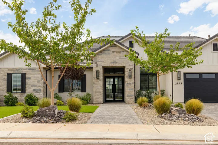 Stone and stucco exterior with dark-framed windows