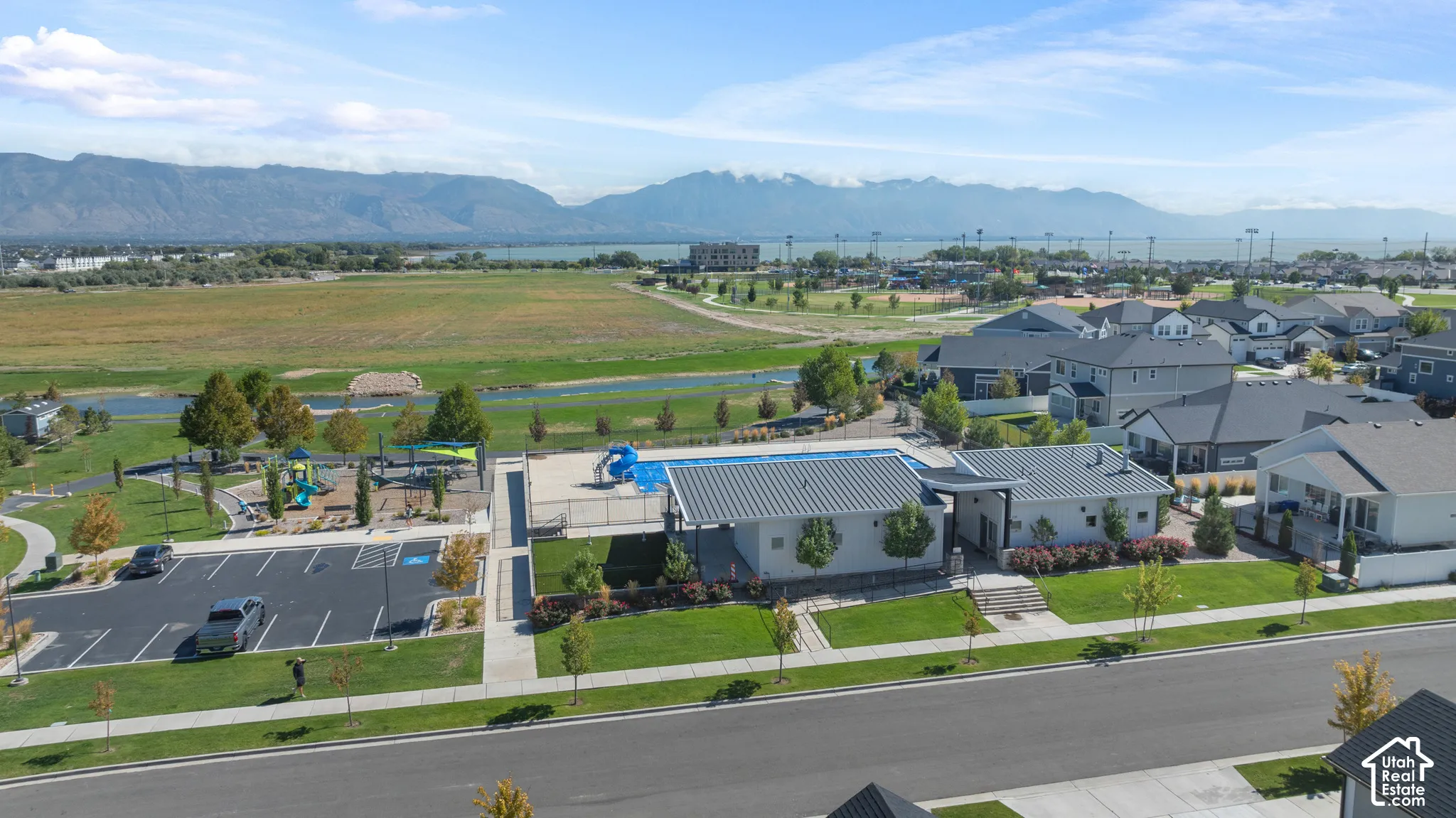 Community playground, paved parking area, and residential street