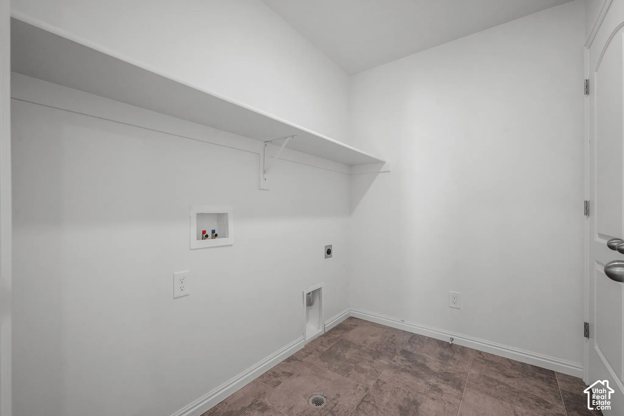 Dedicated laundry second floor with bedrooms, built-in shelving, and wood-finish flooring