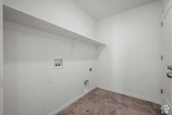 Dedicated laundry second floor with bedrooms, built-in shelving, and wood-finish flooring