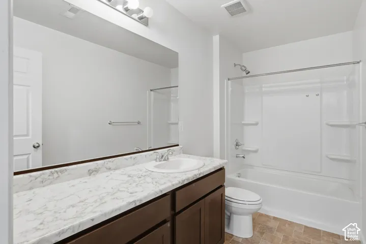White vanity with a single basin sink, integrated countertop, and chrome faucet