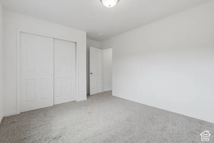 Neutral wall finishes complemented by light gray carpeting