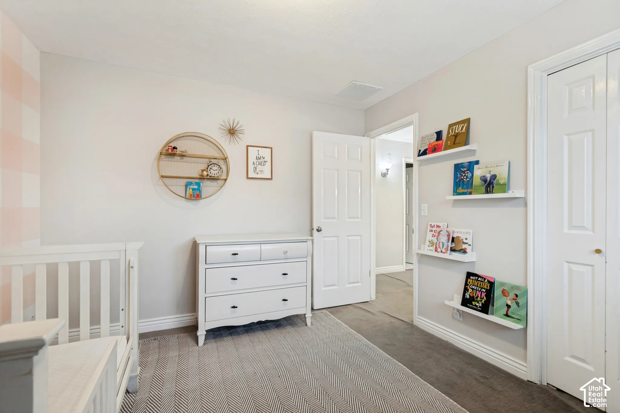 Recessed lighting, baseboard trim, wall-mounted floating shelves, and paneled doors