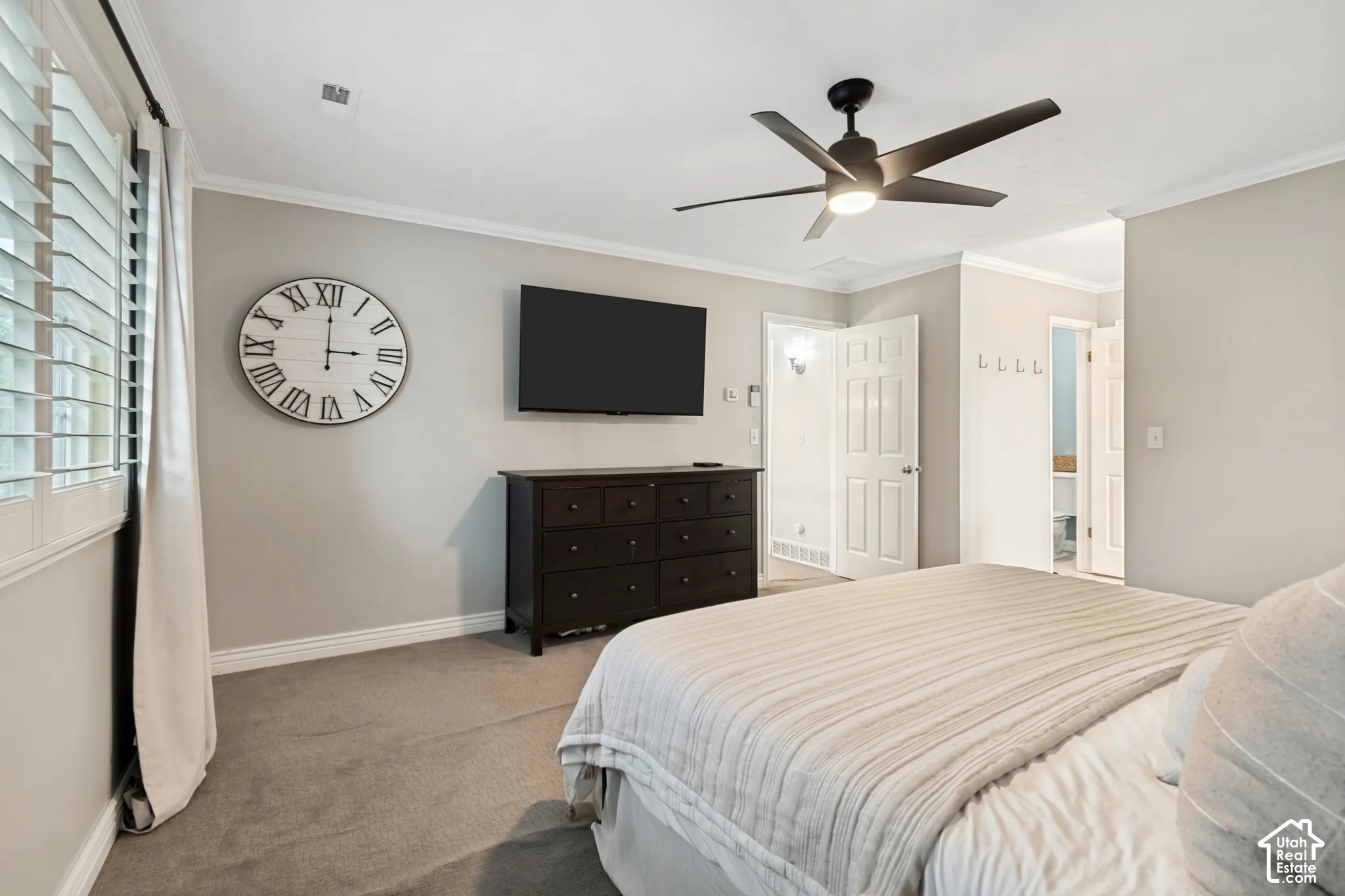 Recessed lighting, crown molding, ceiling fan with integrated light, carpeted flooring, and plantation shutters