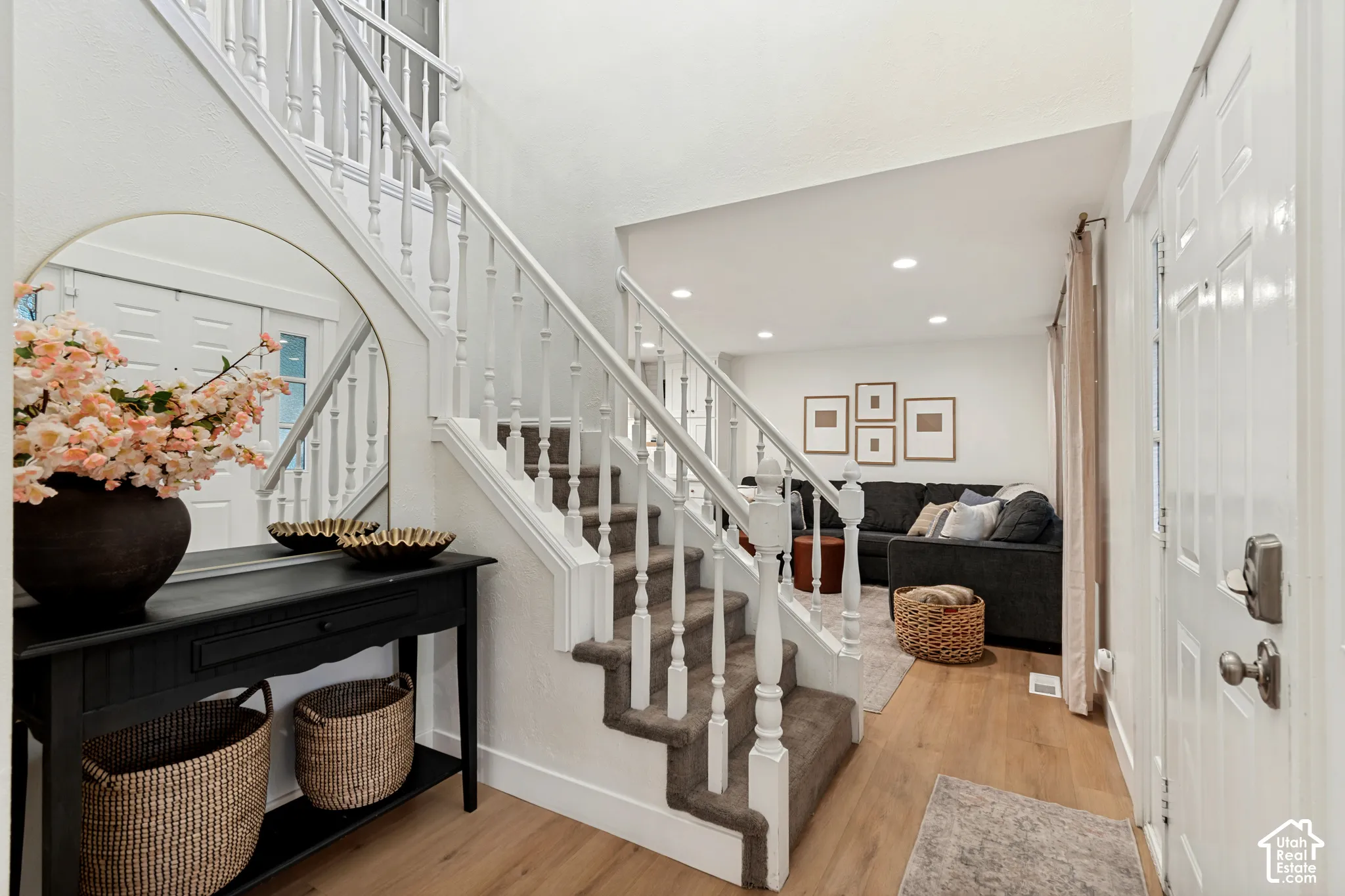 Bright entry foyer featuring wood-finish flooring